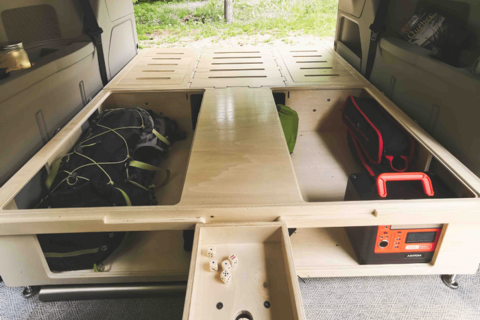 Smart storage solution in the Roadloft minivan conversion kit for optimized space usage.