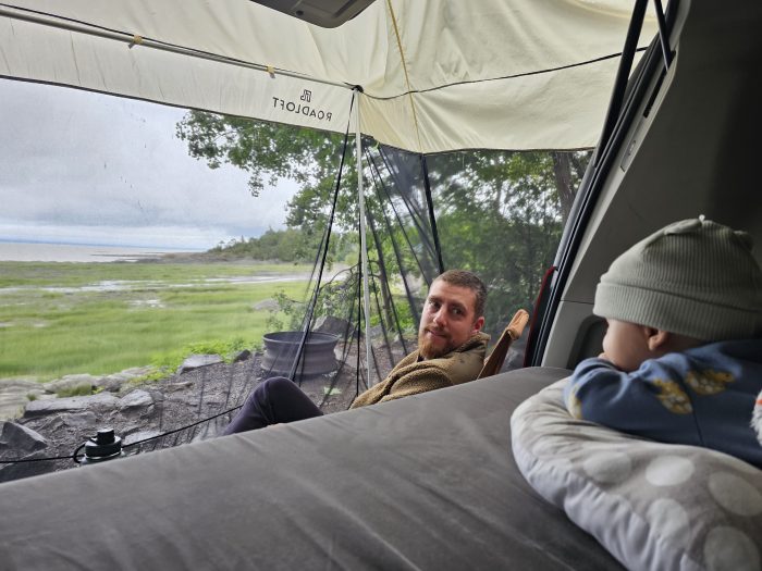 Mosquito net shelter for pickup trucks with Roadloft kit, providing protection from insects while camping outdoors.